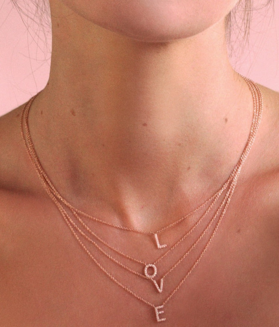 Argyle pink diamonds letter necklace worn by fashion model