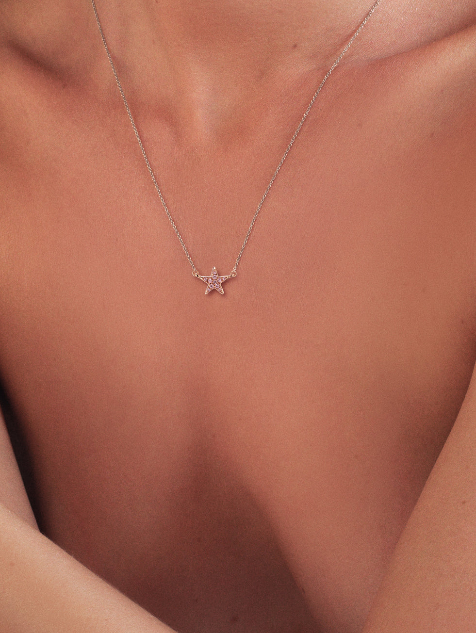 Model wearing Pink Diamond star pendant in 14K rose gold